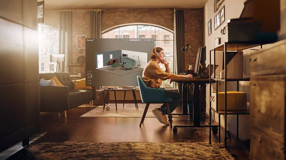 A person viewing the Fixtuur 3D Room Planner Platform on their screen in an apartment.